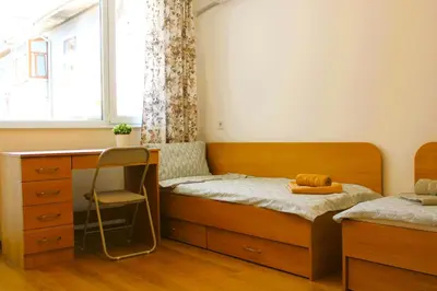 a bedroom with a bed and a desk and a window at Bright & Cozy Apartment for 4 Guests in Plovdiv Centre in Plovdiv