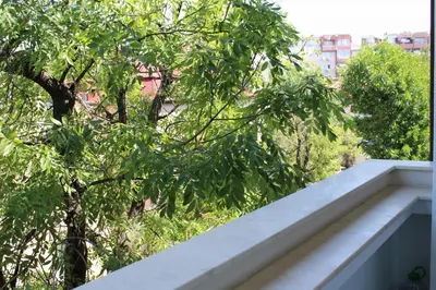 a view of a tree from a balcony at Bright & Cozy Apartment for 4 Guests in Plovdiv Centre in Plovdiv