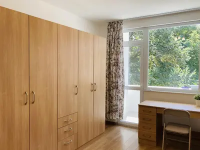 a home office with wooden cabinets and a window at Bright & Cozy Apartment for 4 Guests in Plovdiv Centre in Plovdiv