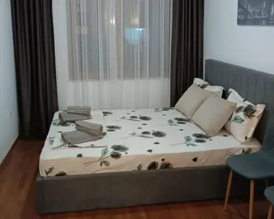 a bedroom with a bed with flowers on it at Bella apartment Bansko in Bansko