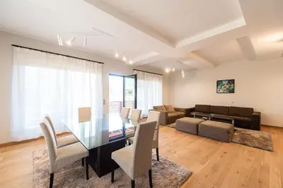 a living room with a dining table and a couch at Къща за гости 