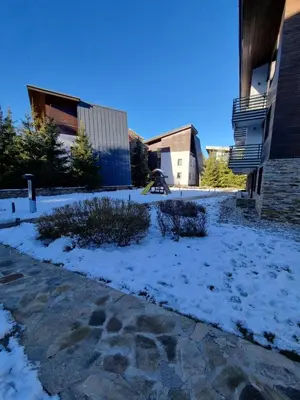 a yard covered in snow next to a building at Private Studio Pine Whisper 4 pax in Euphoria Club in Borovets