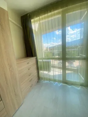 a bedroom with a large window with a view at Student City Vitosha View Apartment in Sofia