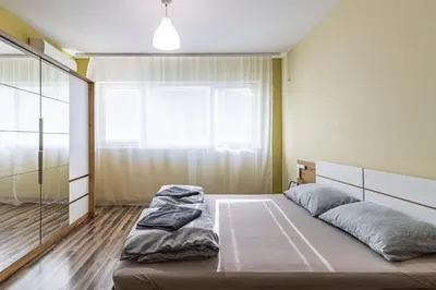 a bedroom with a bed and a large window at 20th Residence Studio in Sofia