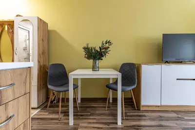 a room with a table with two chairs and a tv at 20th Residence Studio in Sofia