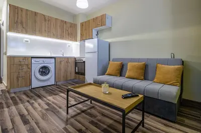 a living room with a couch and a table at 20th Residence One Bedroom Apartment - Private Parking Included in Sofia