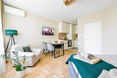 a living room with a bed and a dining room at Sunny Sofia Studio with Balcony by Flat Mаnager in Sofia