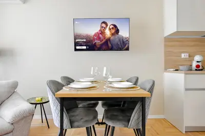 a dining room table with a movie poster on the wall at Sunny Sofia Studio with Balcony by Flat Mаnager in Sofia