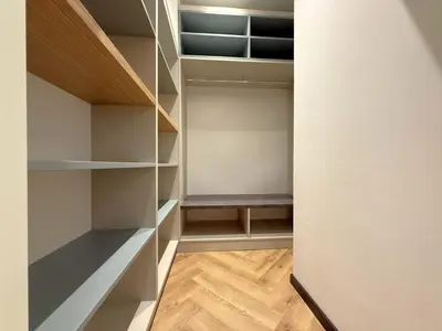 a walk in closet with a bench in it at London - English Basement Studio in Sofia