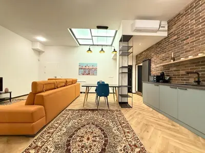 a living room with a couch and a table at London - English Basement Studio in Sofia