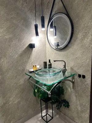 a bathroom with a glass sink and a mirror at Къща за гости Рилски чардак in Sapareva Banya