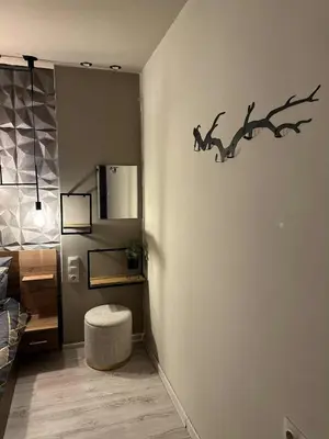 a room with a wall with a branch on the wall at Къща за гости Рилски чардак in Sapareva Banya