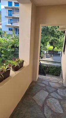 a balcony with potted plants in a building at Къща за гости Рилски чардак in Sapareva Banya