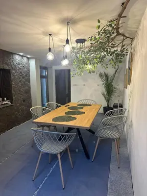a wooden table and chairs in a room at Къща за гости Рилски чардак in Sapareva Banya