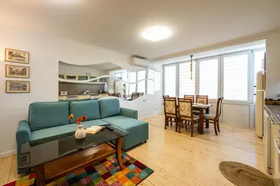 a living room with a blue couch and a table at Bendida Classic in Velingrad
