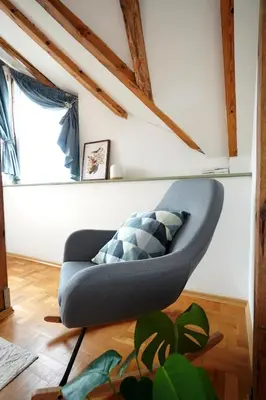 a blue couch in a room with a window at Modern Loft with Balcony in the heart of Sofia in Sofia