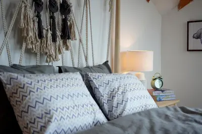 a bedroom with a bed with pillows and a lamp at Modern Loft with Balcony in the heart of Sofia in Sofia