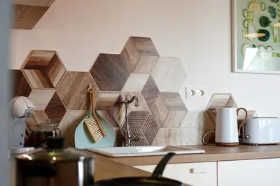 a kitchen counter with a geometric tile wall at Modern Loft with Balcony in the heart of Sofia in Sofia