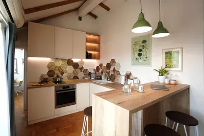 a kitchen with white cabinets and a wooden counter top at Modern Loft with Balcony in the heart of Sofia in Sofia