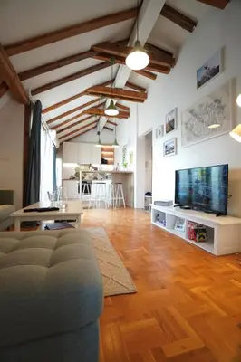 a living room with a couch and a flat screen tv at Modern Loft with Balcony in the heart of Sofia in Sofia