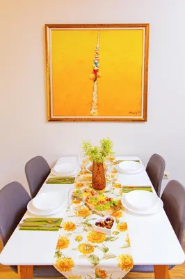 a dining room table with a floral table cloth at Domus Apartment Amber with Parking in Plovdiv