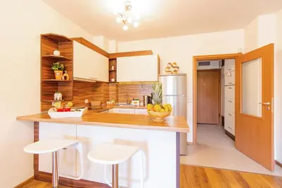 a kitchen with a counter with a bowl of fruit on it at Domus Apartment Amber with Parking in Plovdiv