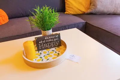 a birthday cake sitting on a table with a plant at Domus Apartment Amber with Parking in Plovdiv