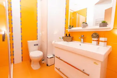 a bathroom with a sink and a toilet at Domus Apartment Amber with Parking in Plovdiv