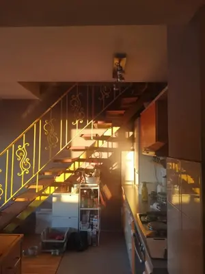 a stairway in a kitchen with a stair case at Artsy Penthouse & mountain view in Sofia