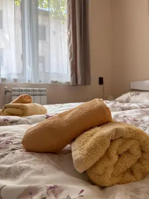 a bedroom with two beds with towels on them at Apartment Hristina in Dobrinishte
