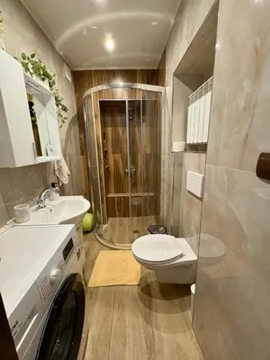 a bathroom with a shower and a toilet and a sink at Apartment Hristina in Dobrinishte