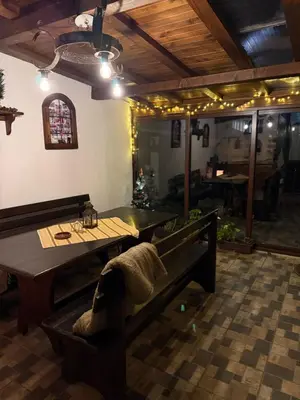 a dining room with a table and a bench at Apartment Hristina in Dobrinishte