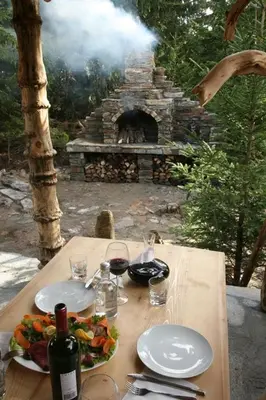 a wooden table with plates of food and wine at Oxygen Time in Smolyan