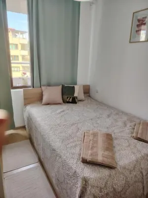 a bedroom with a bed with two towels on it at Apartament Khan Kubrat in Sandanski