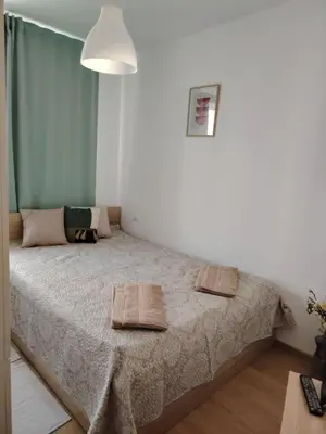 a bedroom with a bed with two towels on it at Apartament Khan Kubrat in Sandanski
