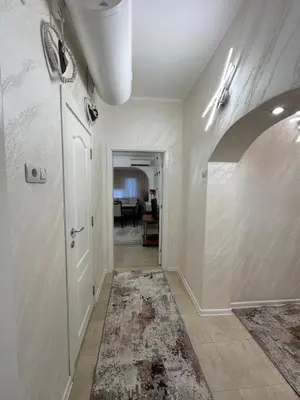an empty hallway with a white door and a room at Apartament Avangard in Pazardzhik