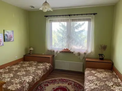 a bedroom with two beds and a window at The Old Walnut House in Terziysko