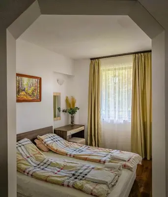 a bedroom with two beds and a window at Everwood Hotel & Restaurant in Govedartsi