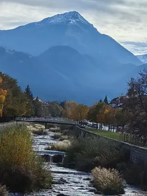 a mountain in the distance with a river and a bridge at Апартамент Мария in Bansko