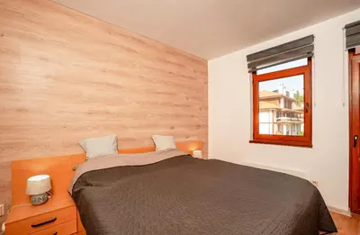 a bedroom with a bed and a window at Oxygen Time in Smolyan