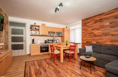 a living room with a couch and a table and chairs at Oxygen Time in Smolyan
