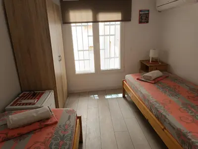 a bedroom with two beds and a window at Wendy House - Central Sofia - 3BRDR - Private Courtyard - 5 min to Vitosha blvd in Sofia