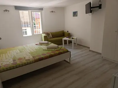 a small bedroom with a bed and a couch at Wendy House - Central Sofia - 3BRDR - Private Courtyard - 5 min to Vitosha blvd in Sofia