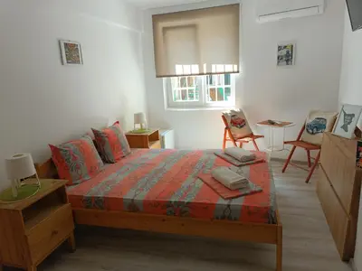 a bedroom with a bed and a table and chairs at Wendy House - Central Sofia - 3BRDR - Private Courtyard - 5 min to Vitosha blvd in Sofia