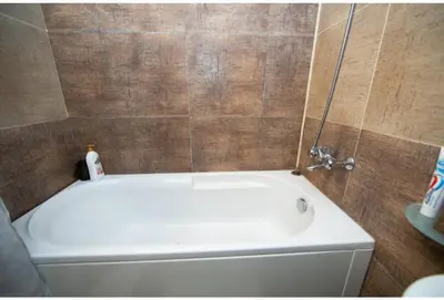 a white bath tub in a bathroom at Madzharovi Apartments in Borovets
