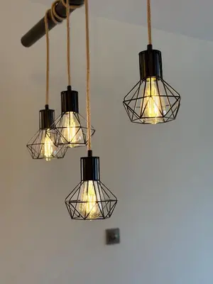a group of lights hanging from a wall at Madzharovi Apartments in Borovets