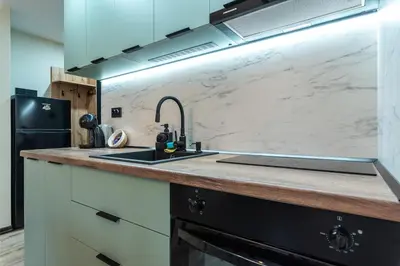 a kitchen with a sink and a refrigerator at Vutovi's corner made with care 2 in Bansko