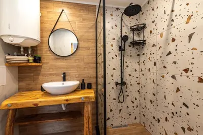 a bathroom with a sink and a shower at Vutovi's corner made with care 2 in Bansko