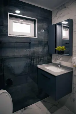 a bathroom with a sink and a window at Royal View Guest House in Dospat