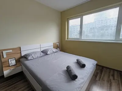 a bedroom with a large bed with two slippers on it at 20th Residence Studio 1 in Sofia